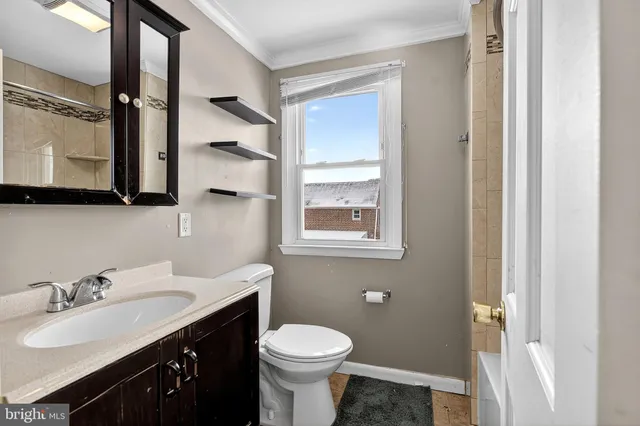a bathroom with a sink toilet and mirror
