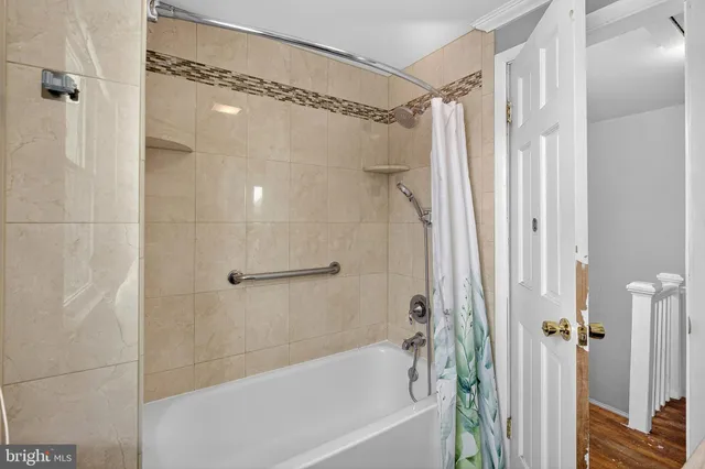 a bathroom with a shower and a bath tub