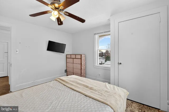 a bedroom with a bed and a tv