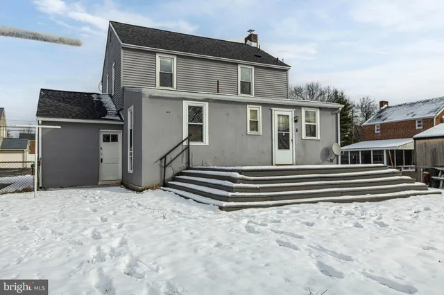 a view of a house with wooden fence