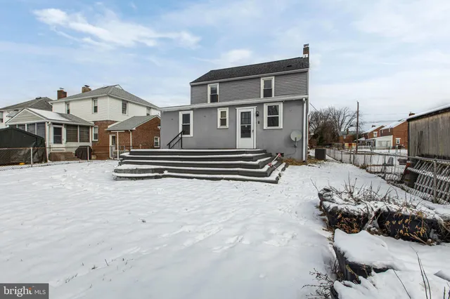 a view of a house with a wooden fence