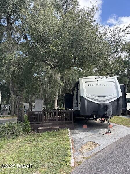 25161 Northeast 140th Loop Salt Springs, FL 32134 - Photo 5 of 45 a view of a dinning table and chairs in the patio