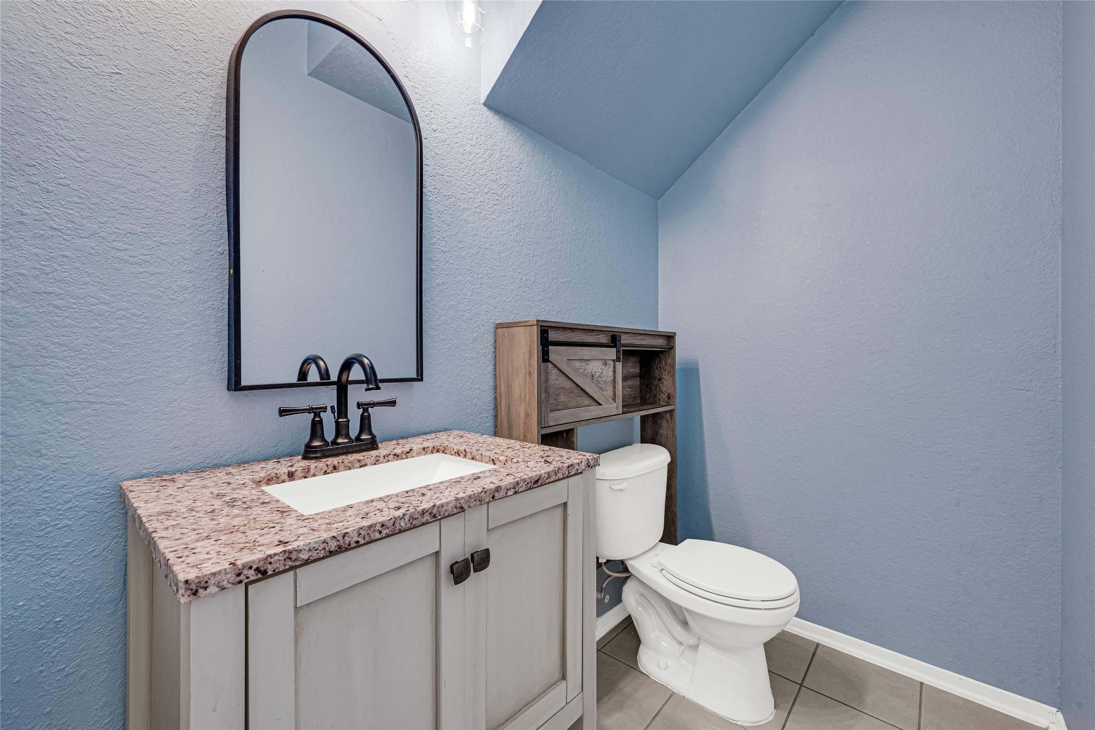 21831 Mossy Field Lane Spring, TX 77388 - Photo 13 of 26 a bathroom with a granite countertop toilet a sink and a mirror