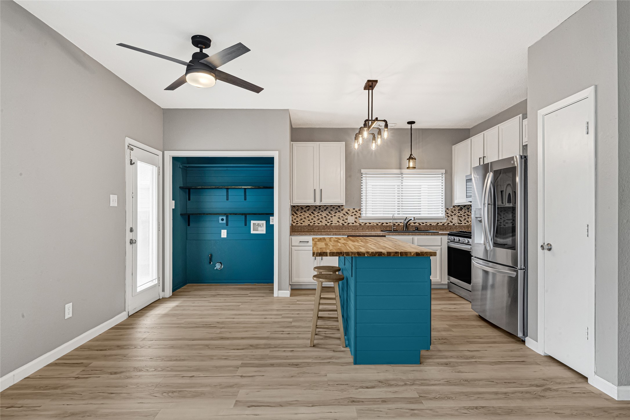21831 Mossy Field Lane Spring, TX 77388 - Photo 8 of 26 a kitchen with kitchen island white cabinets and stainless steel appliances