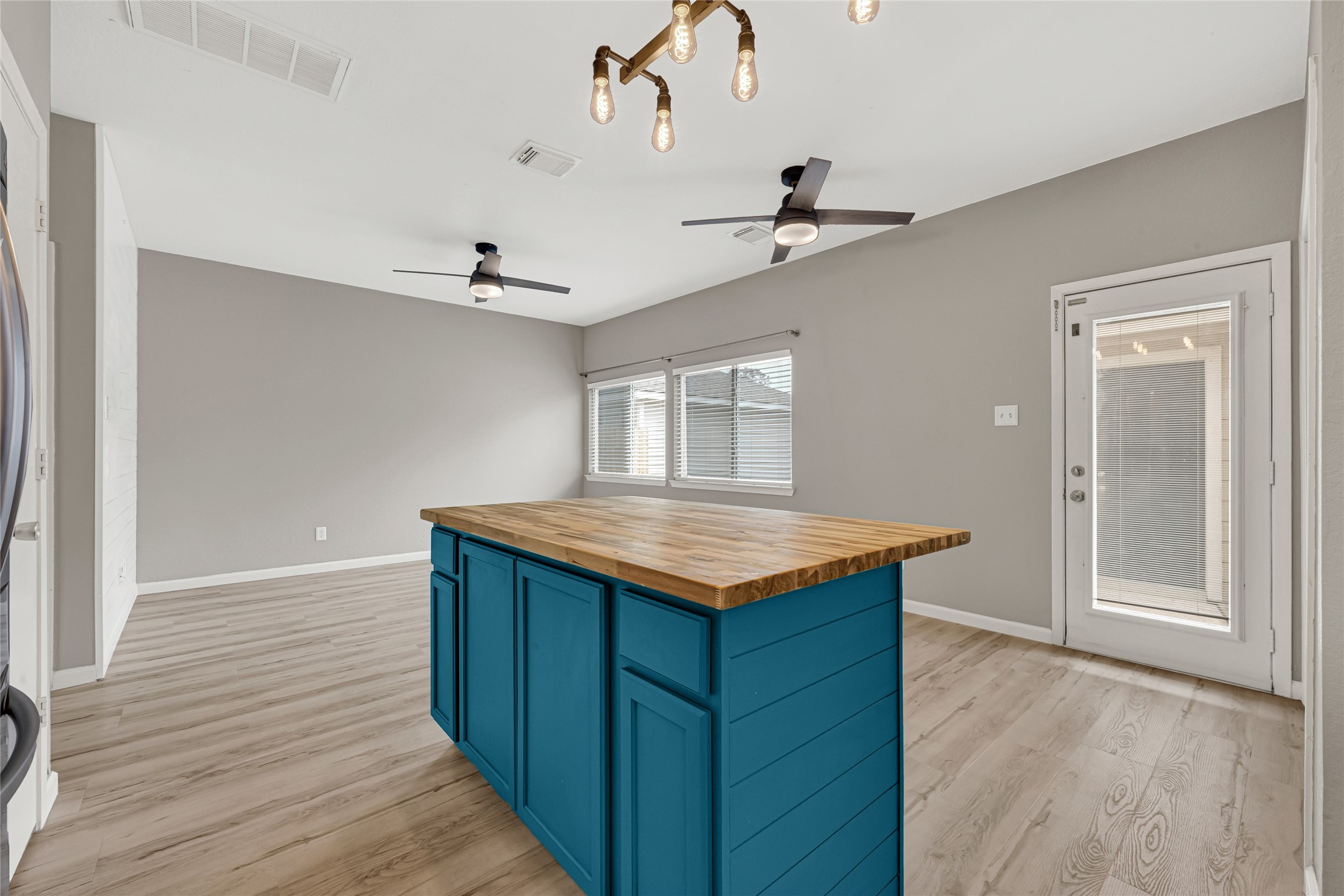 21831 Mossy Field Lane Spring, TX 77388 - Photo 9 of 26 wooden floor in an empty room with a kitchen