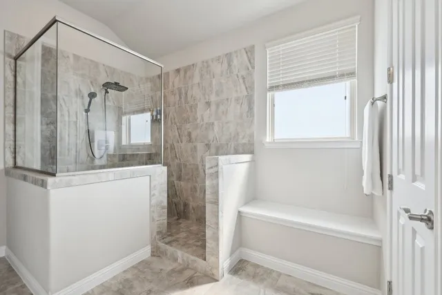 a bathroom with a shower and a bath tub