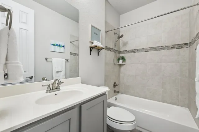 a bathroom with a sink a mirror toilet and bathtub
