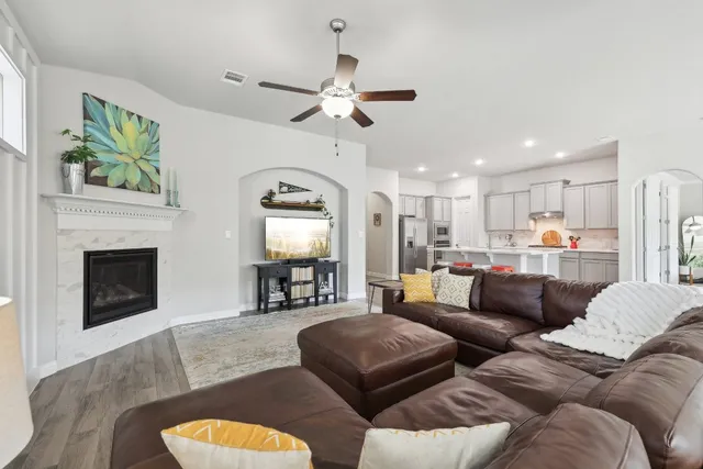 a living room with furniture and a fireplace