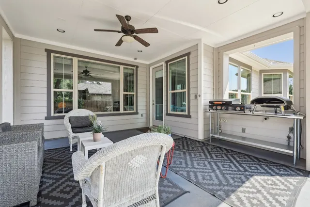 a living room with furniture two window and chairs