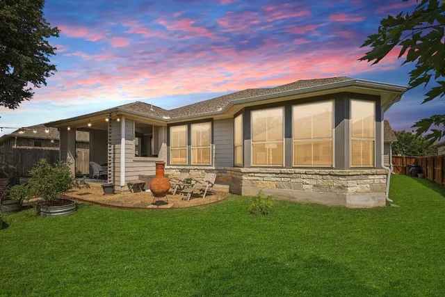 a front view of a house with a garden and yard
