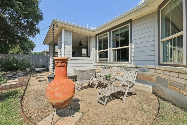 a view of a chair and table in the patio