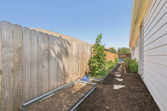 a view of a pathway with a wooden fence