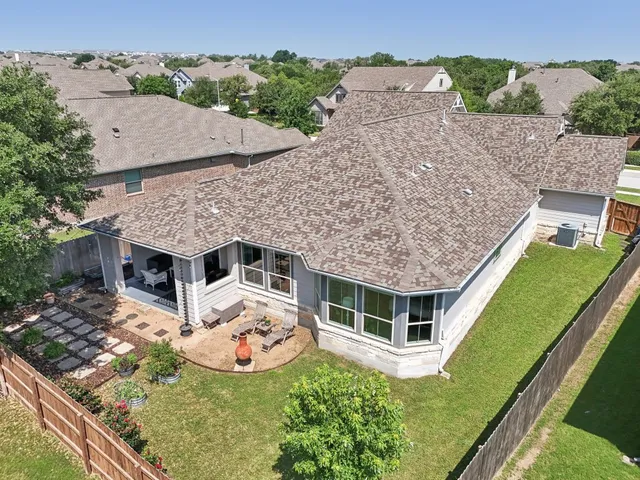 an aerial view of a house with a yard