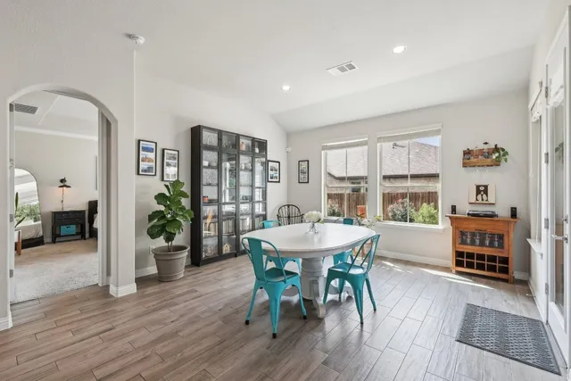 a dining room with furniture and wooden floor