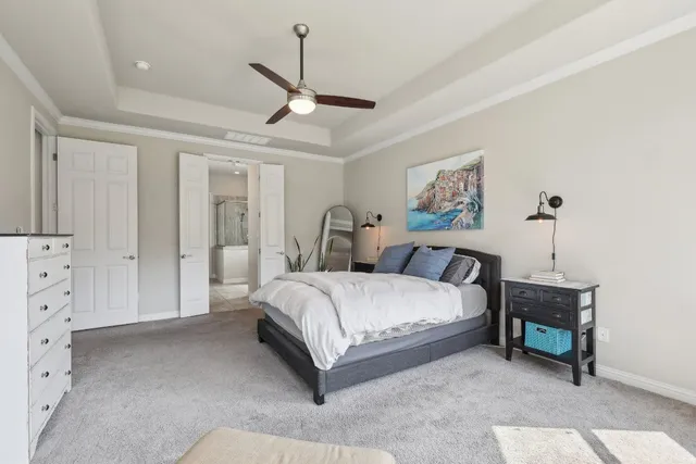 a spacious bedroom with a bed and a cabinets