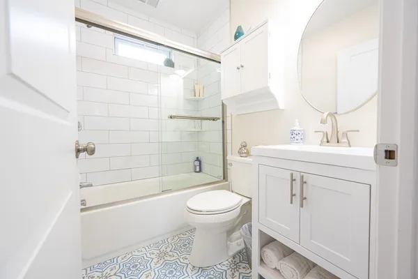 a bathroom with a sink toilet and shower