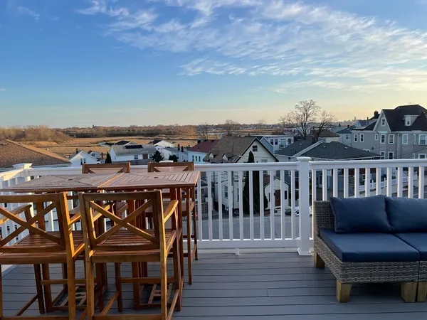 a view of a chairs and table on the deck