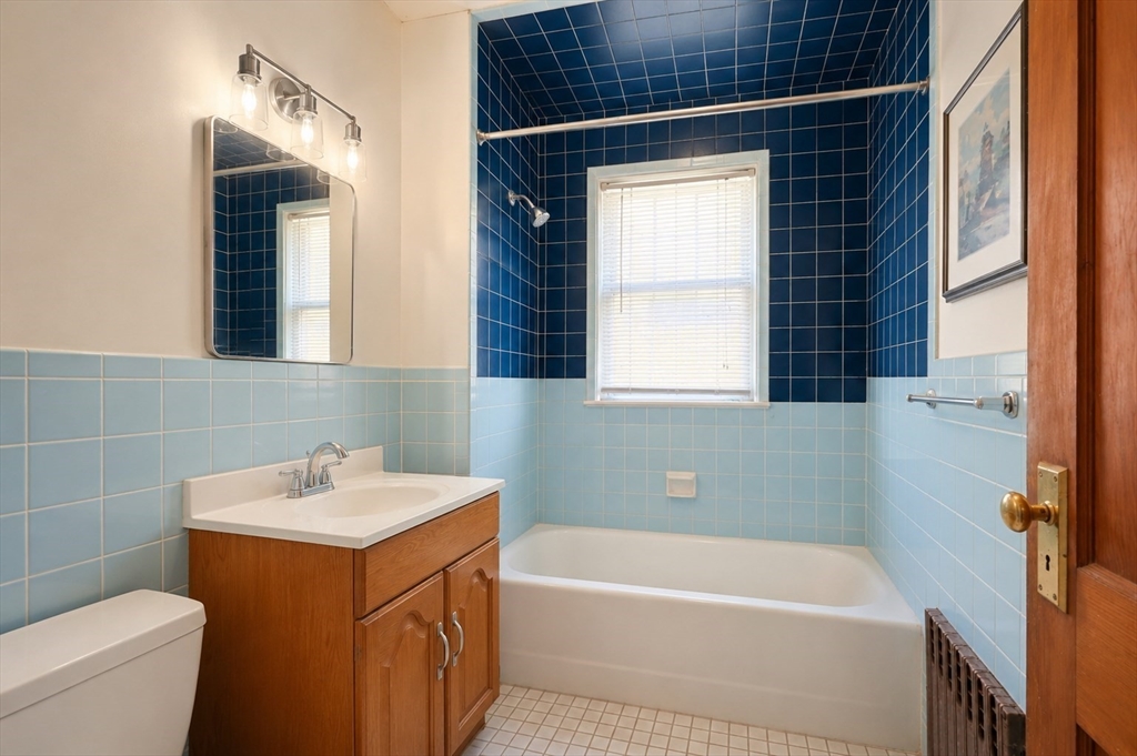 157 Elm Street Somerville, MA 02144 - Photo 5 of 19 a bathroom with a sink a toilet and a bathtub