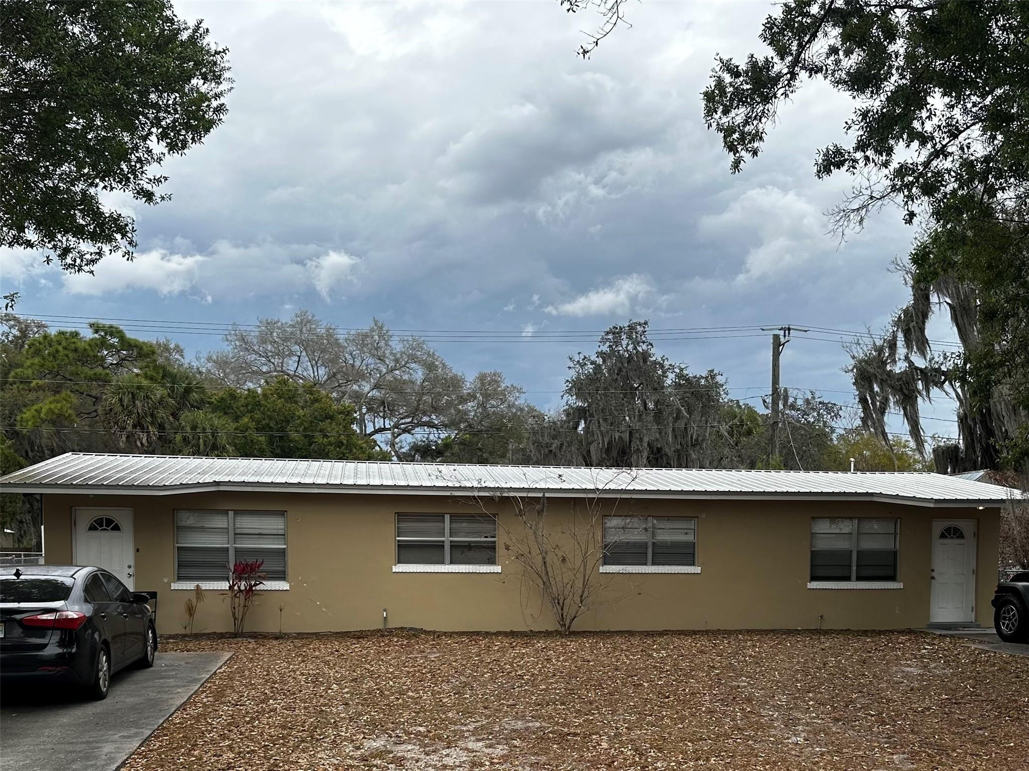 817 Southeast 9th Street Okeechobee, FL 34974 - Photo 1 of 13 a view of parking area in back of a house