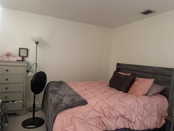 a bedroom with a bed and a chair
