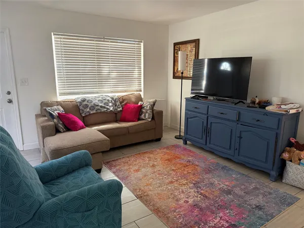 a living room with furniture and a flat screen tv