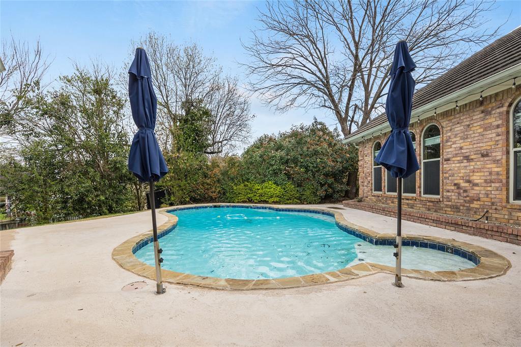 1201 Findlay Drive Arlington, TX 76012 - Photo 32 of 35 a swimming pool with lots of tress in the background
