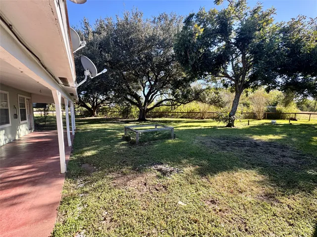 a swimming pool with outdoor seating and yard
