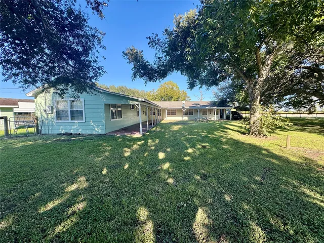 a backyard of a house with table and chairs