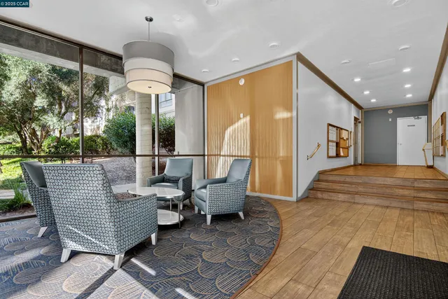 a living room with furniture a chandelier and a table