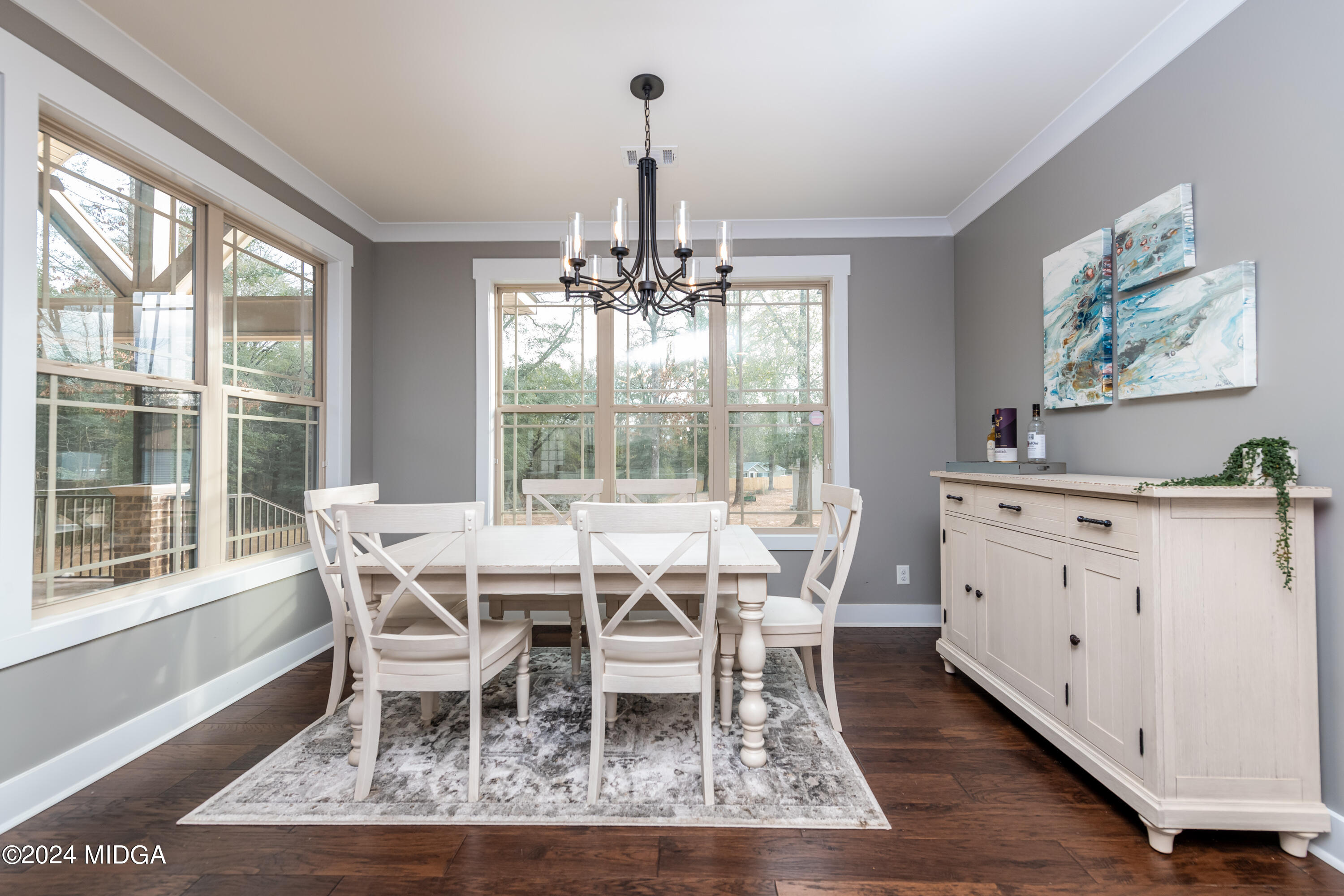 158 Harper Road Perry, GA 31069 - Photo 10 of 46 a view of a dining room with furniture wooden floor and a chandelier