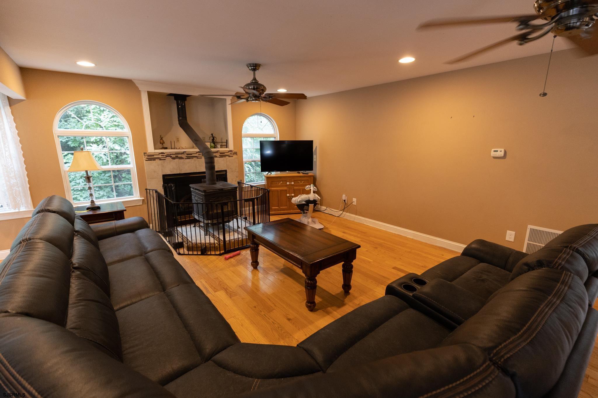 336 Old New York Road Port Republic, NJ 08241 - Photo 12 of 42 a living room with furniture a large window and a flat screen tv