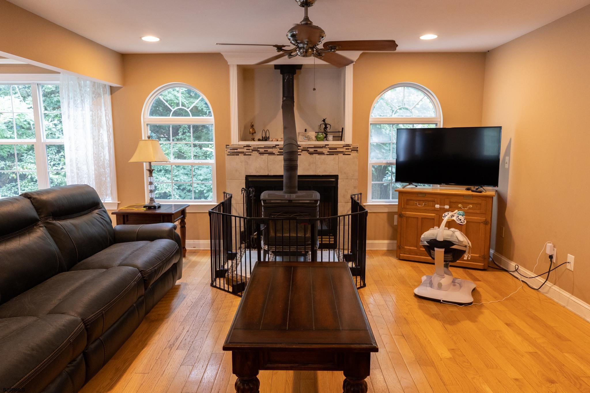 336 Old New York Road Port Republic, NJ 08241 - Photo 13 of 42 a living room with furniture a flat screen tv and a large window