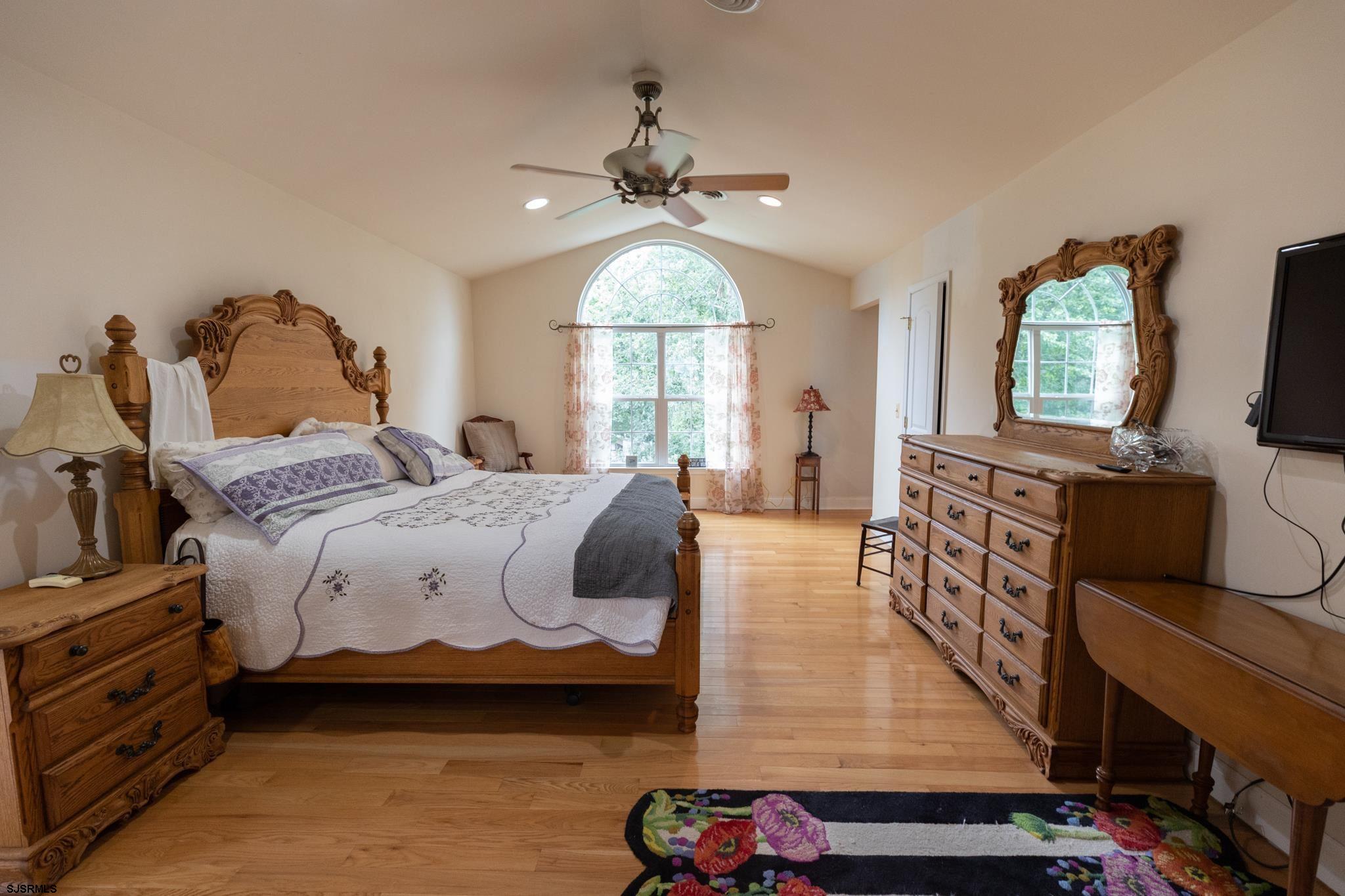 336 Old New York Road Port Republic, NJ 08241 - Photo 18 of 42 a spacious bedroom with a bed and a flat tv screen on dresser