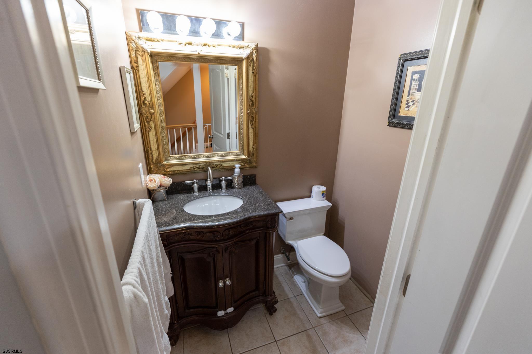 336 Old New York Road Port Republic, NJ 08241 - Photo 41 of 42 a bathroom with a granite countertop sink toilet a mirror and a shower