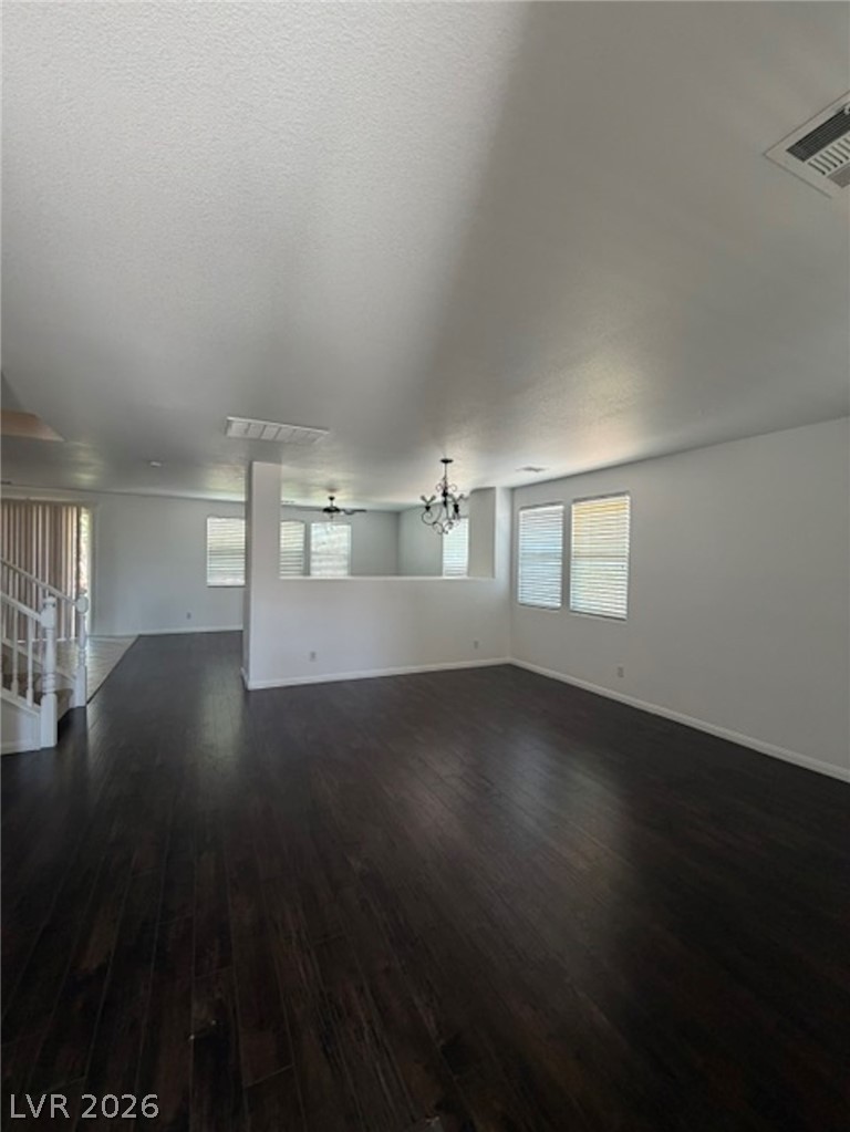 3862 Landing Ridge Place Las Vegas, NV 89135 - Photo 2 of 26 Rich hardwood flooring creates a luxurious foundation in this airy, open-concept living space.