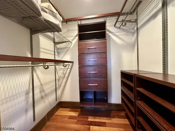 a bathroom with a glass door shower and vanity