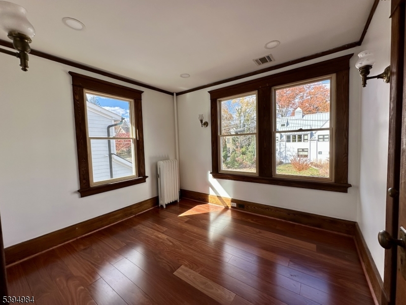 12 Maple Avenue Madison, NJ 07940 - Photo 25 of 39 a view of an empty room with wooden floor and a window