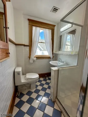 a view of a brick house with a yard and large tree