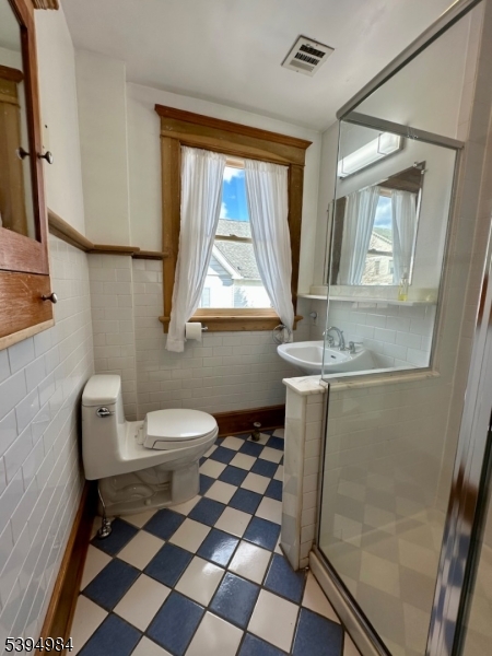 12 Maple Avenue Madison, NJ 07940 - Photo 27 of 39 a bathroom with a toilet a sink and a mirror