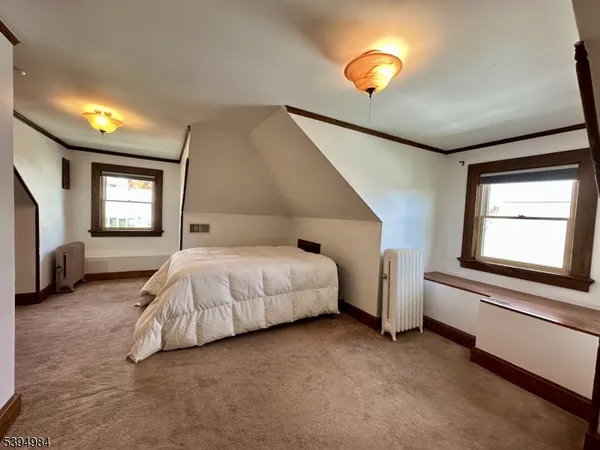 a spacious bedroom with a bed and window