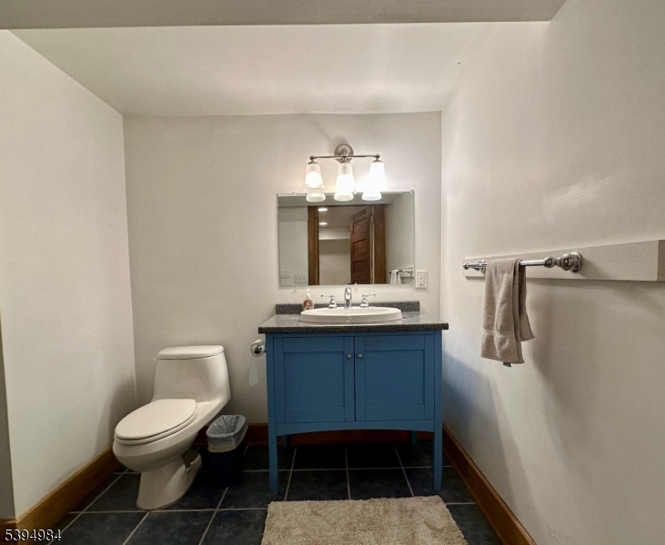 12 Maple Avenue Madison, NJ 07940 - Photo 35 of 39 a bathroom with a sink a toilet and mirror