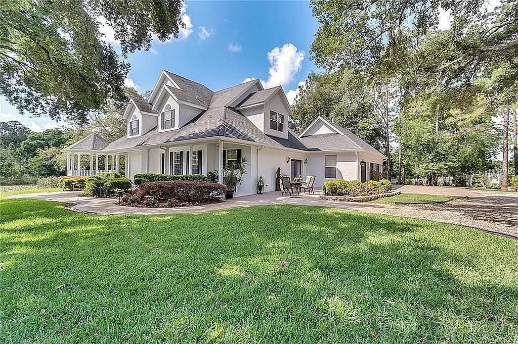 5526 Tiny Road Winter Garden, FL 34787 - Photo 1 of 39 a front view of a house with a garden