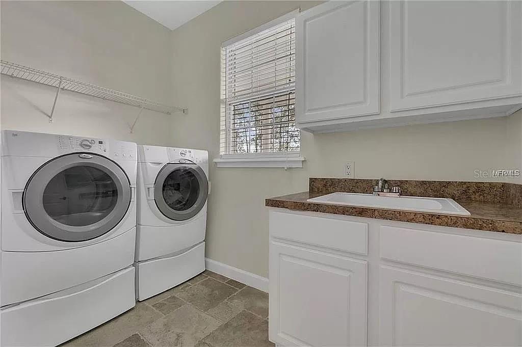 5526 Tiny Road Winter Garden, FL 34787 - Photo 14 of 39 a utility room with dryer and washer