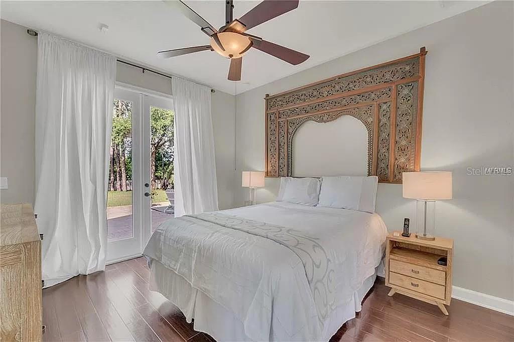 5526 Tiny Road Winter Garden, FL 34787 - Photo 15 of 39 a bedroom with a bed and a chandelier