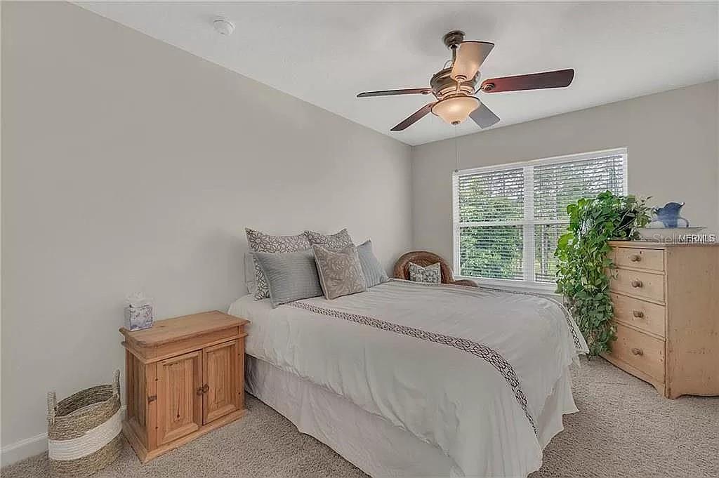5526 Tiny Road Winter Garden, FL 34787 - Photo 17 of 39 a bedroom with a bed and a chandelier