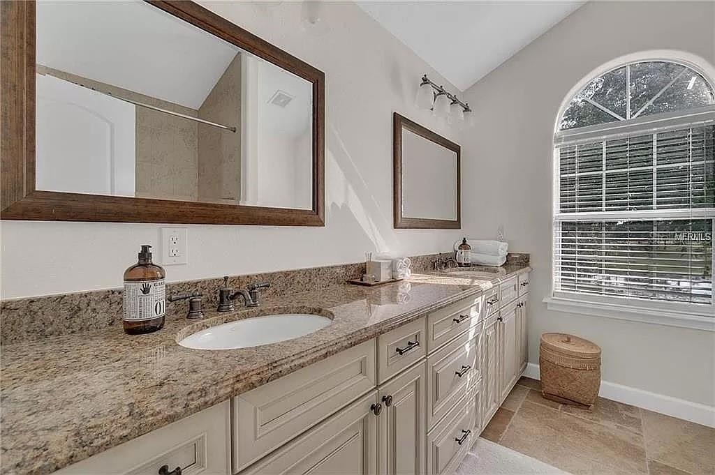 5526 Tiny Road Winter Garden, FL 34787 - Photo 18 of 39 a bathroom with a granite countertop sink and a mirror