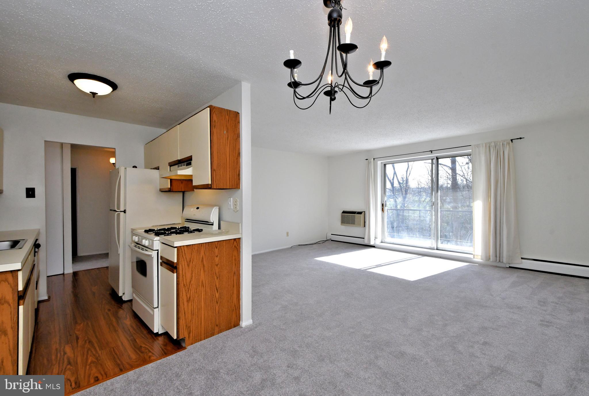 120 North Bethlehem Pike, Unit 208A Fort Washington, PA 19034 - Photo 12 of 25 a large kitchen with stainless steel appliances granite countertop a stove and a wooden floors