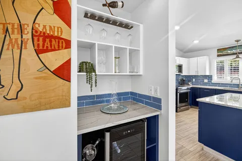 a kitchen with stainless steel appliances granite countertop a sink a stove and cabinets