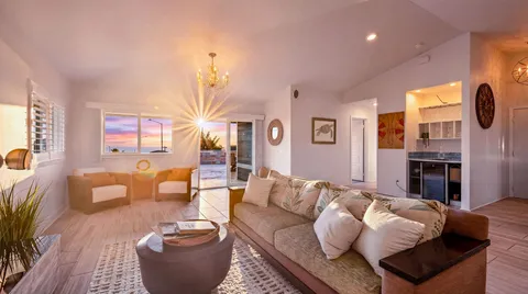 a living room with furniture fireplace and a large window