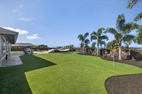 an aerial view of a house with a garden and trees